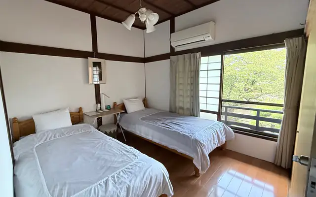 Sakura room with two single beds and garden-facing windows（シングルベッド2台と庭に面した桜の客室）